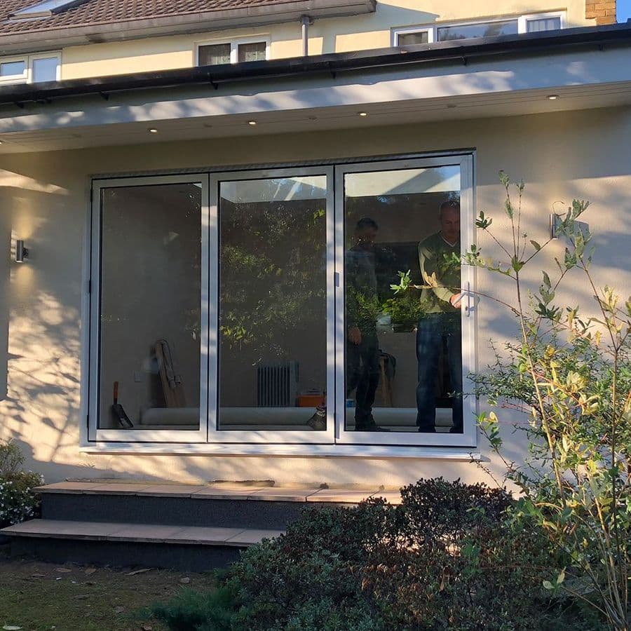 Finished modular extension exterior with grey sliding patio doors